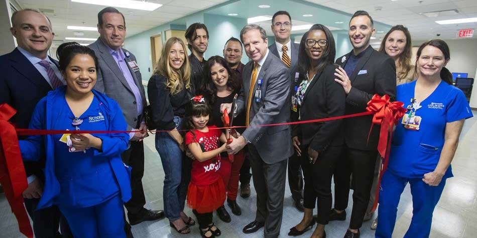 Staff and former patients gather for the ribbon cutting of the new C.I.C.U.